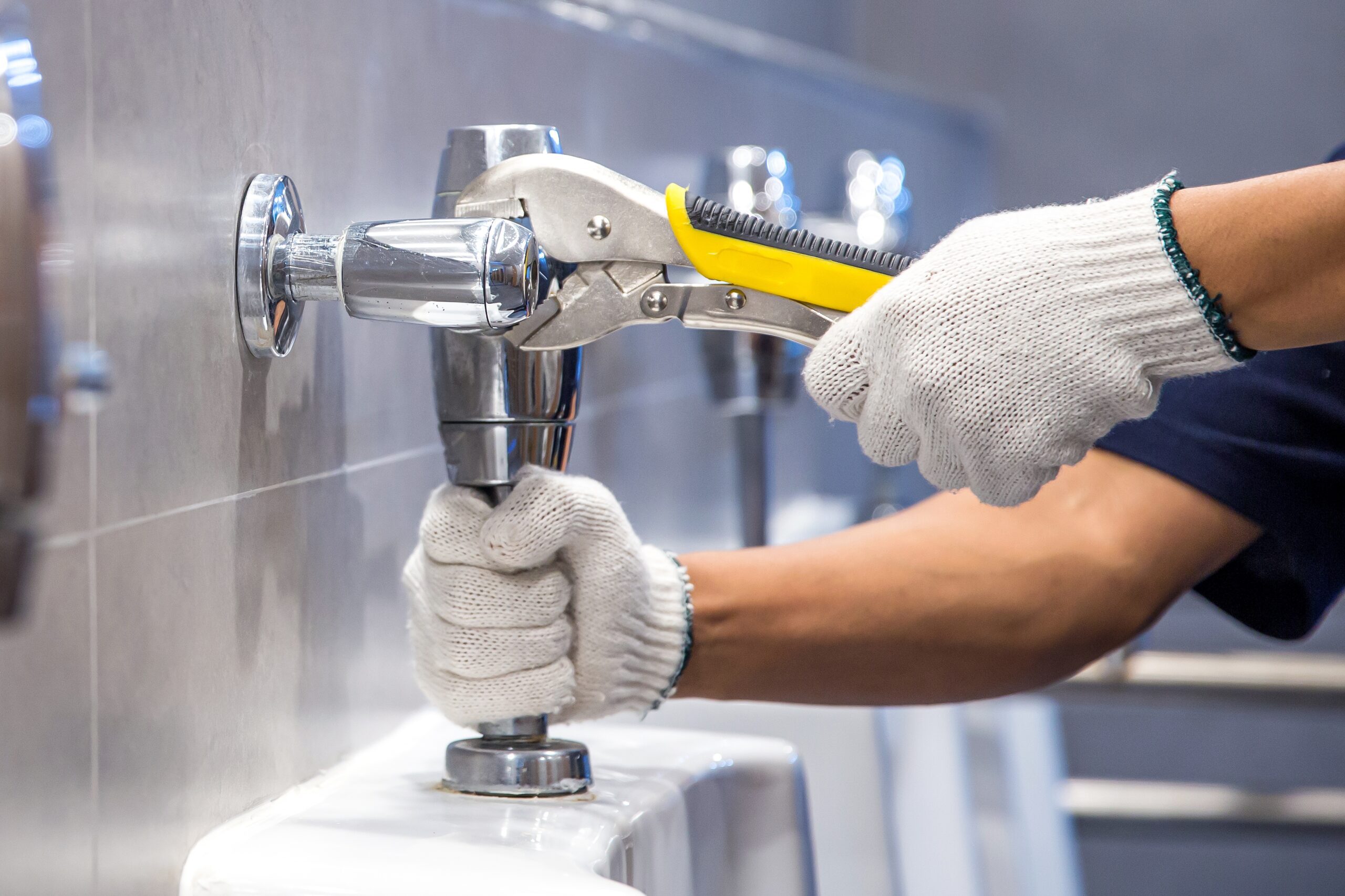 Professional plumber inspecting residential water pipes and fittings