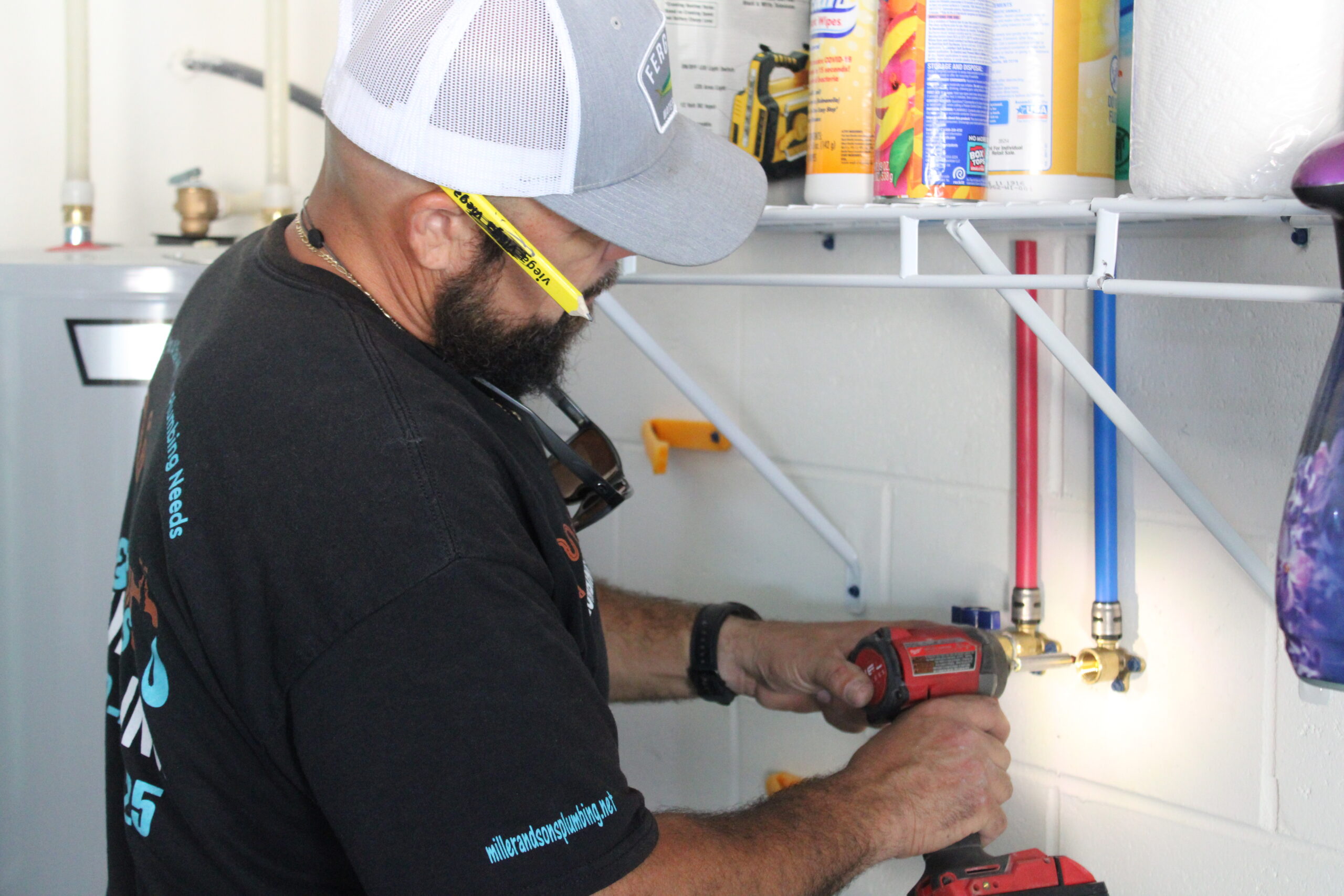 Professional plumber preparing tools and inspecting household plumbing connections